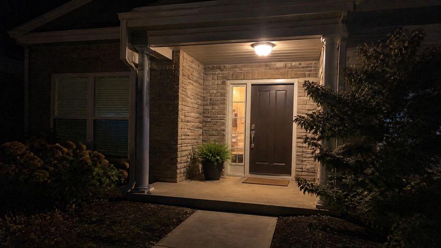 A front porch glowing warm at night.